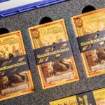 Goldbacks stored in protective currency sleeves inside a secure storage box for preservation