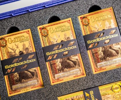 Goldbacks stored in protective currency sleeves inside a secure storage box for preservation